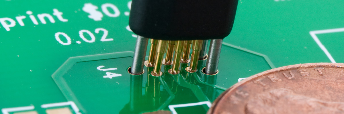 TC2030-NL inserting into PCB with tiny footprint next to coin