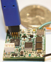 TC2030-NL tiny footprint debug connector inserted into mircrocomputer  PCB