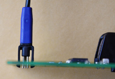 TC2030 legged miniature programming connector inserted into test PCB