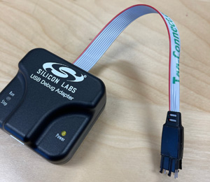 Silicon Labs USB Debug adapter with case closed after installing debug/programming cable